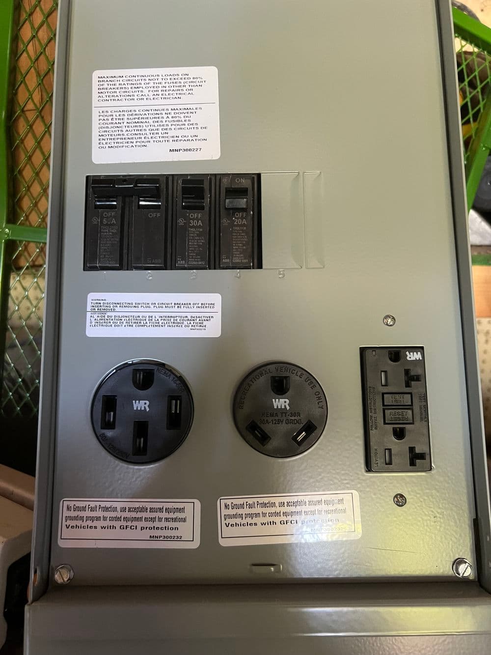 Electrical panel with circuit breakers and GFCI outlets for safe electricity distribution.
