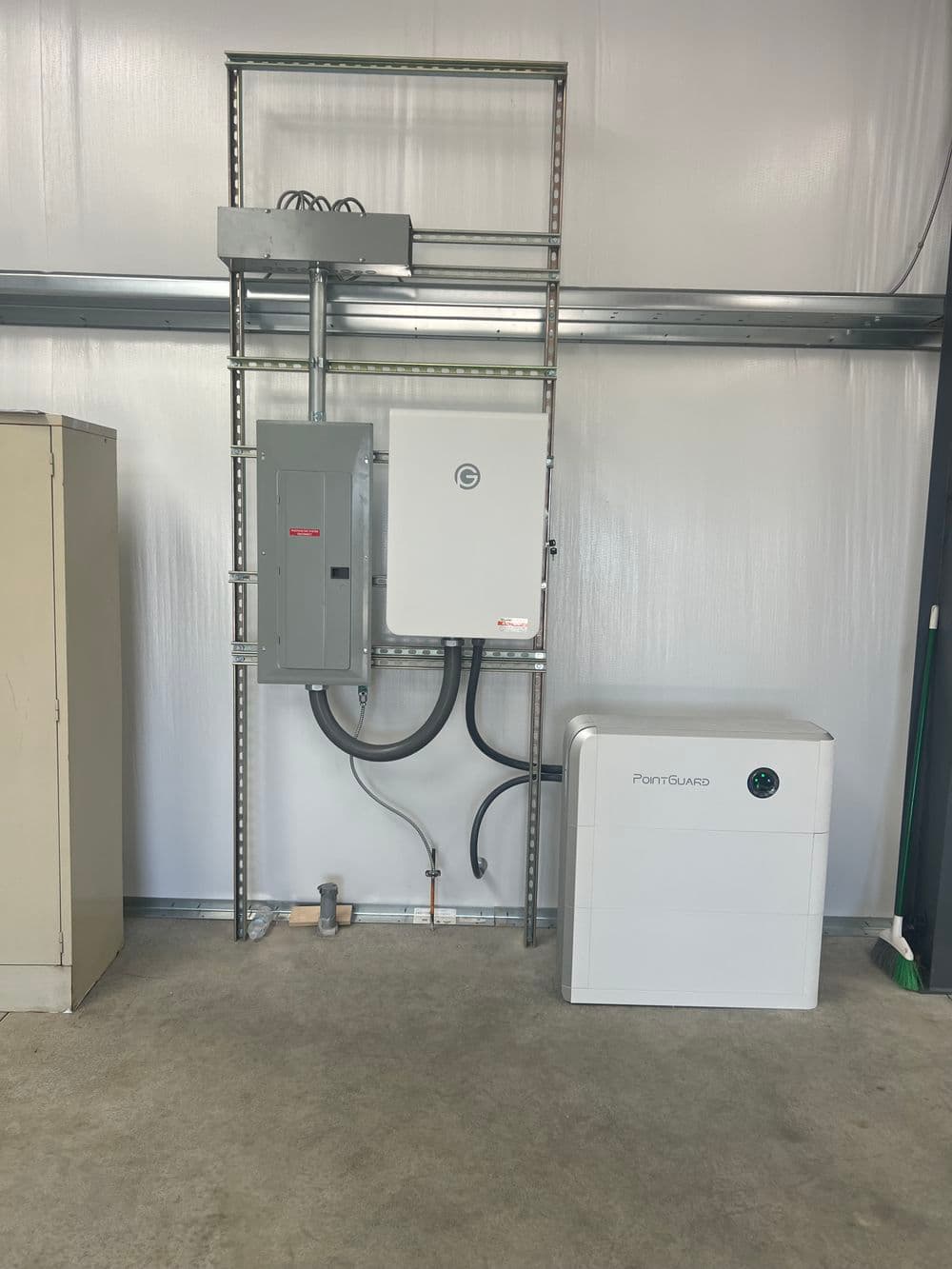 Electrical equipment installation featuring a control panel and PointGuard unit in a warehouse.