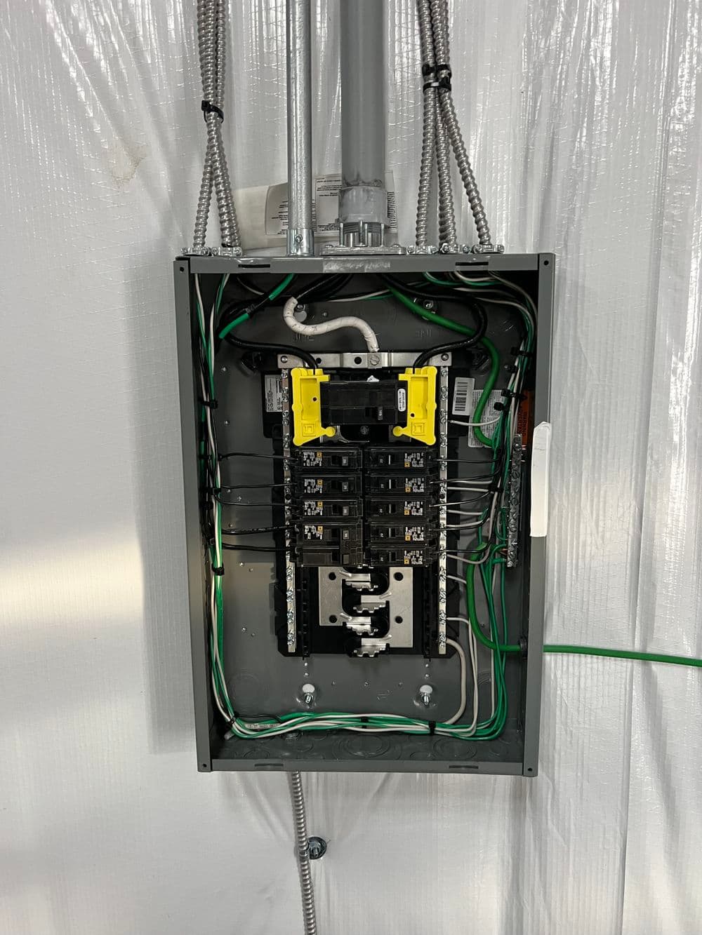 Electrical panel with breakers and wiring in a well-organized setup for residential use.